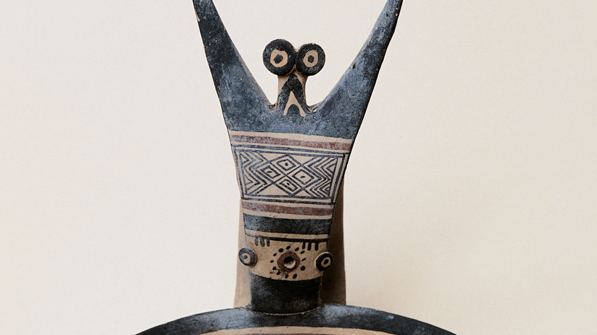 close-up of a human figurine with geometric decoration