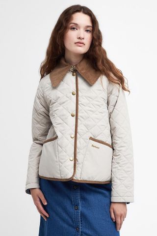 woman wearing cream quilted jacket with corduroy collar and trim