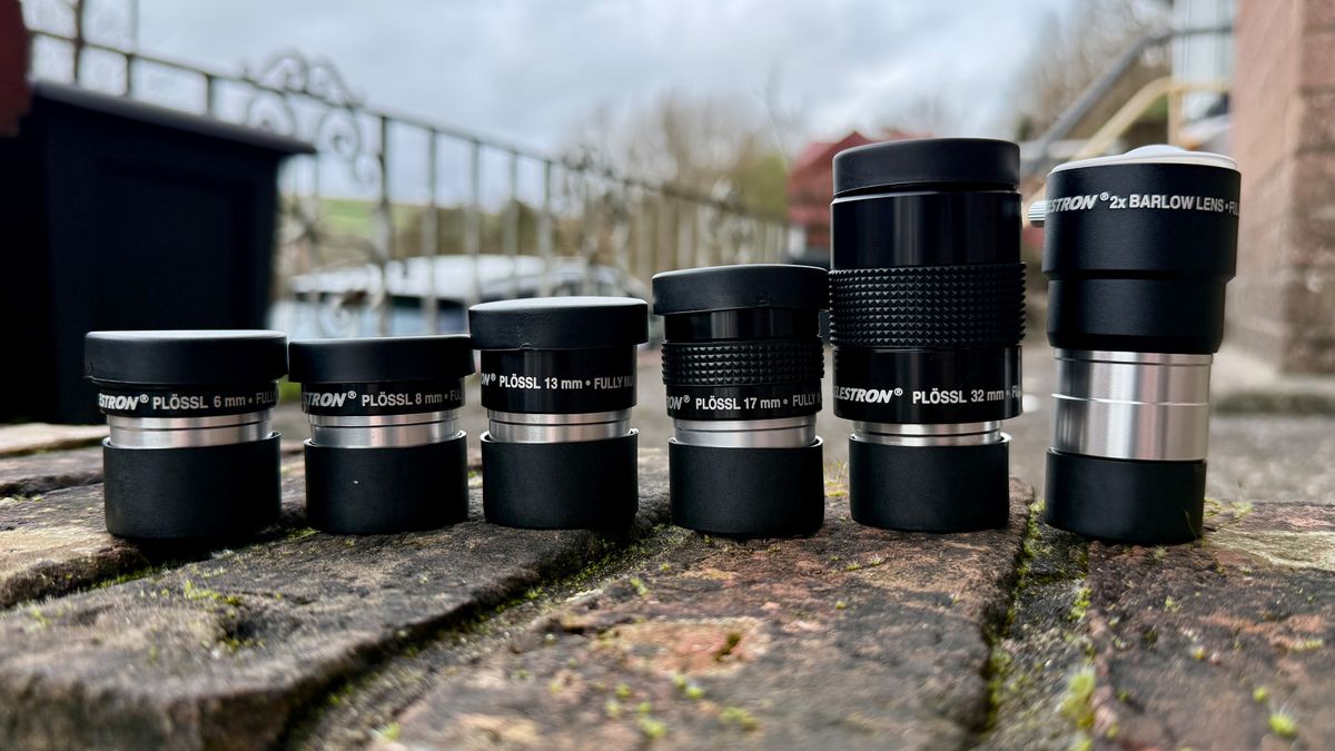 telescope eyepieces lined up on a wall