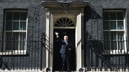 Boris Johnson waves on the steps of 10 Downing Street