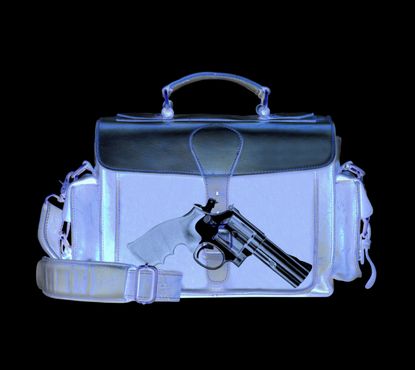 An alarming amount of guns are detected in luggage.