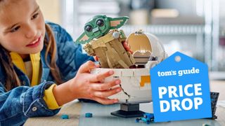 Child building a LEGO Star Wars: The Mandalorian Grogu with Hover Pram set