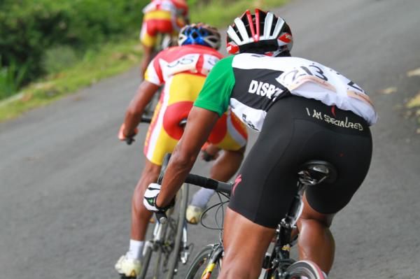 The riders tuck in as they fly down a descent.
