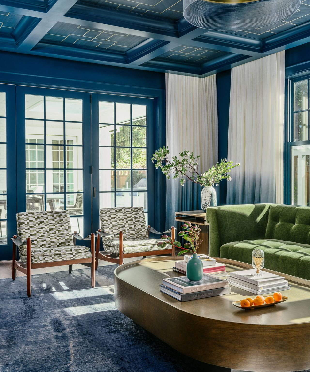 blue living room with twin armchairs and green sofa