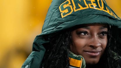 Simone Biles looks on as her husband competes in the NFL.