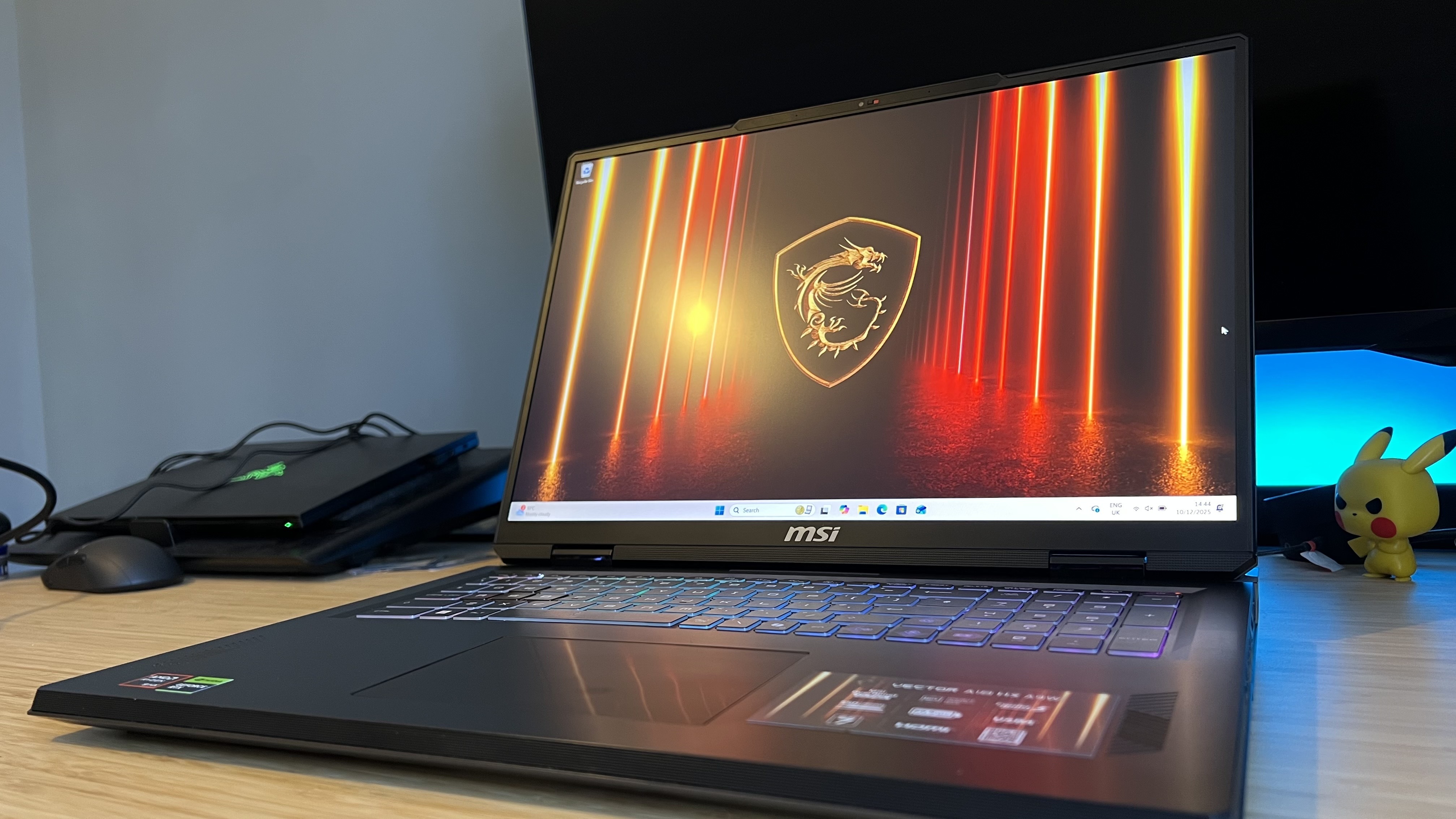 MSI Vector A18 HX A9W gaming laptop on a wooden desk with blue backlighting