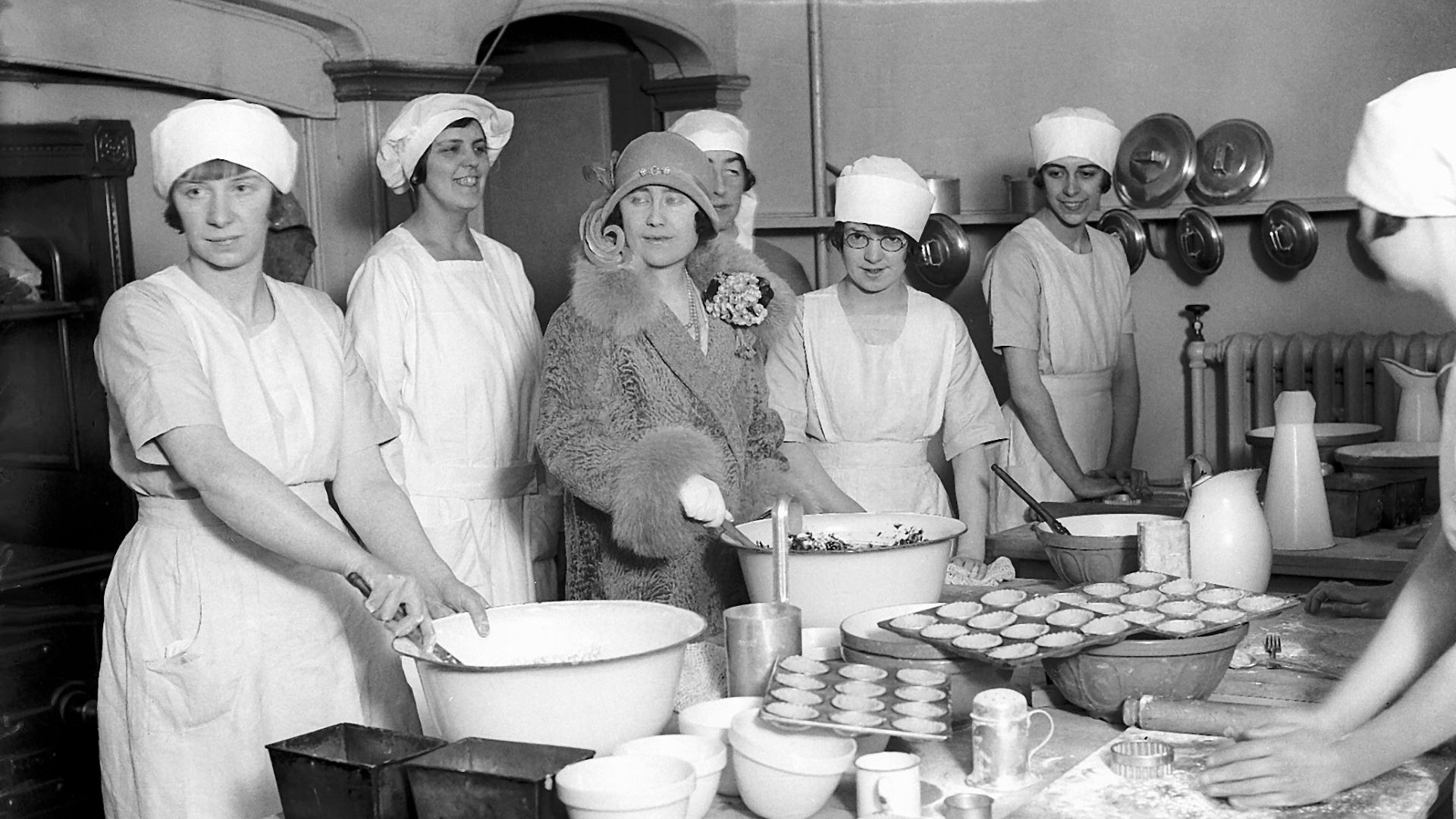 The Queen Mother (when she was the Duchess of York) helps with the preparation of a christmas pudding at Market Harborough December 1927