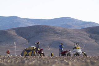 Members of the ARADS team – NASA's Atacama Rover Astrobiology Drilling Studies project – start the day setting up the rover for test runs in Chile's Atacama Desert.