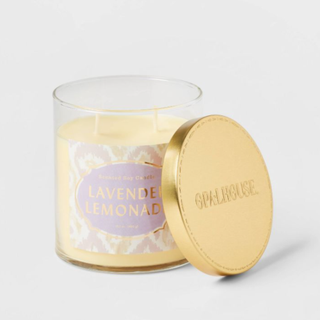 A lavender and lemon candle with a gold lid