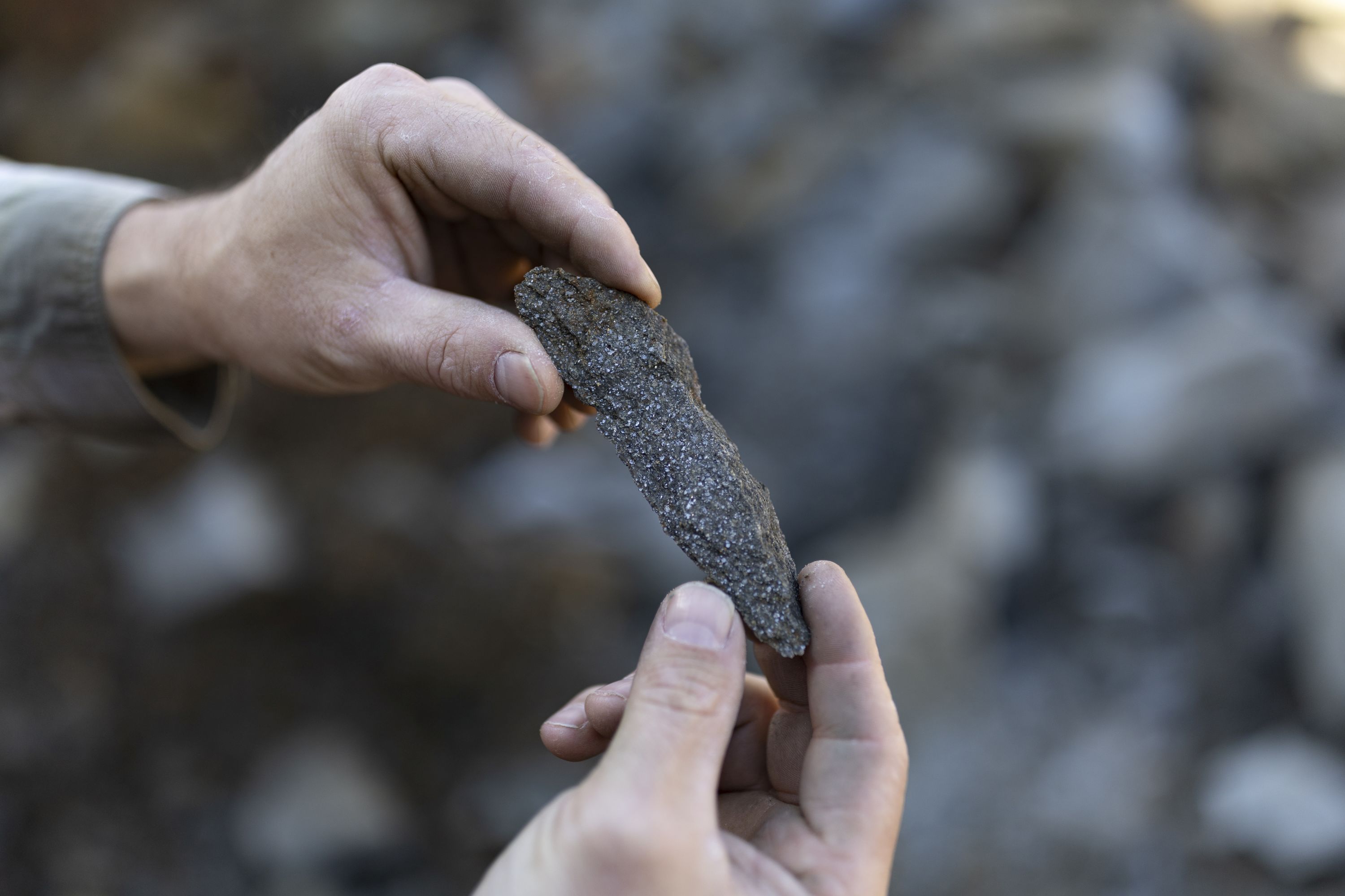 a person holds a piece of graphite