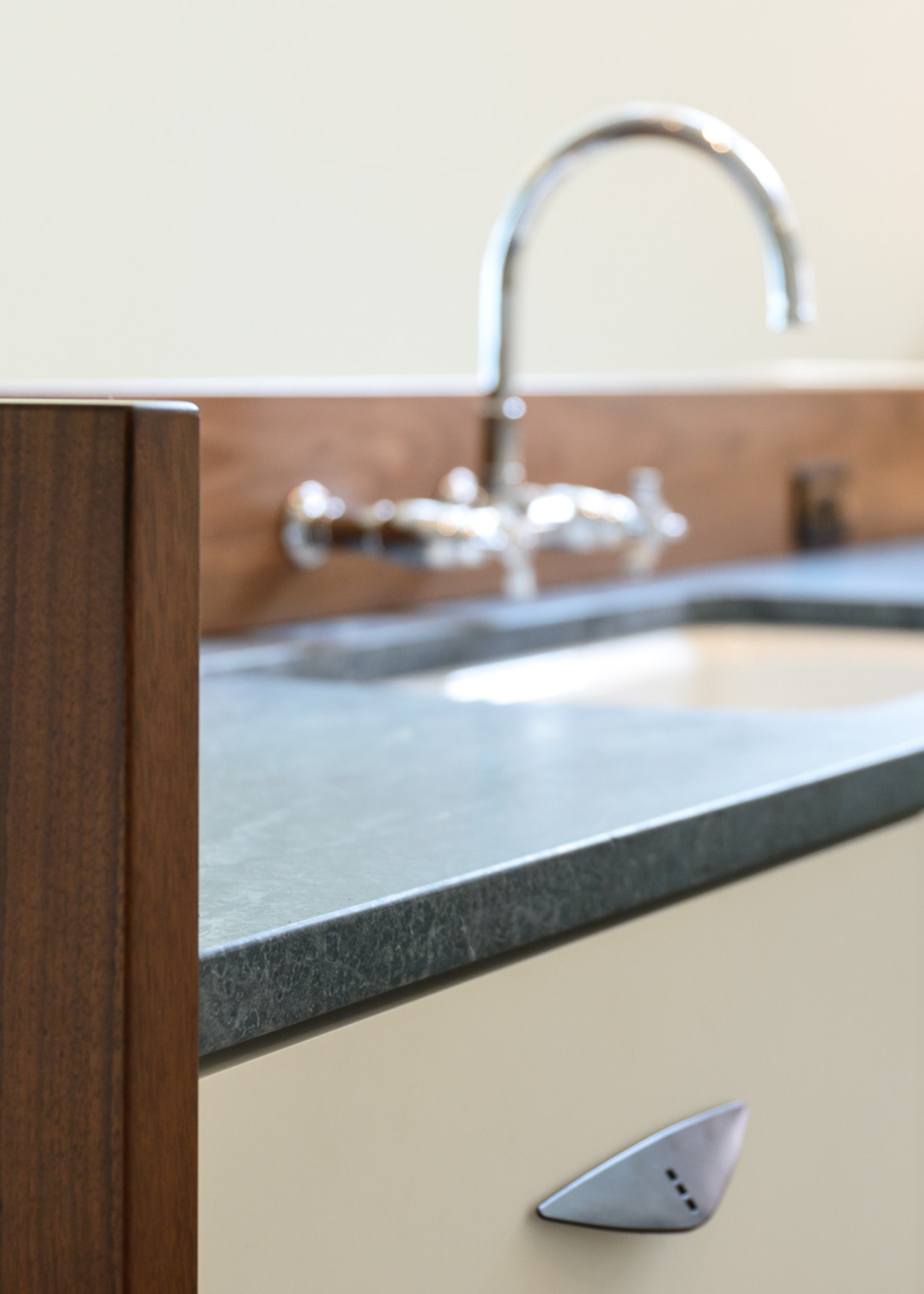 soapstone counter with a sink and silver/chrome hardware
