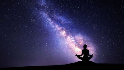 Workout based on star sign: A woman meditating by the stars