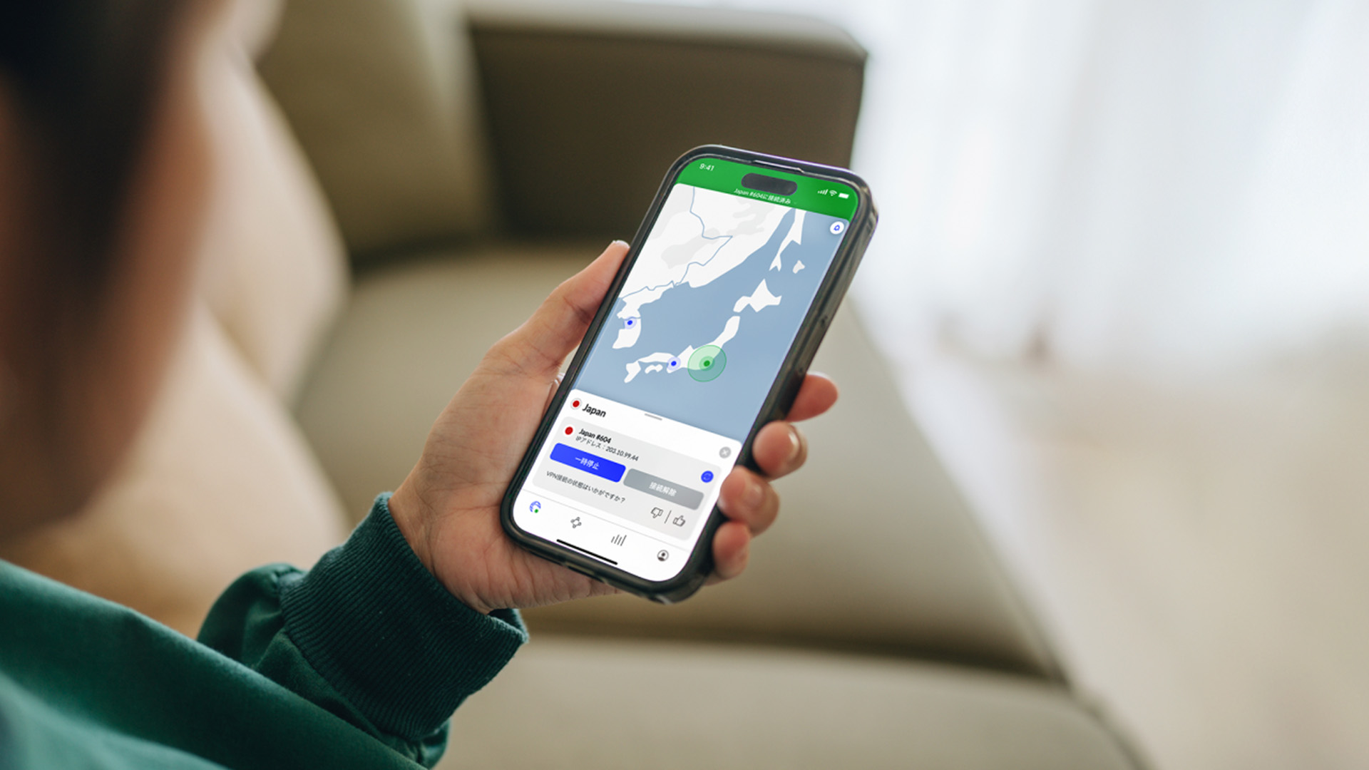 A person holding a mobile phone in their hand with the screen showing a NordVPN connection map