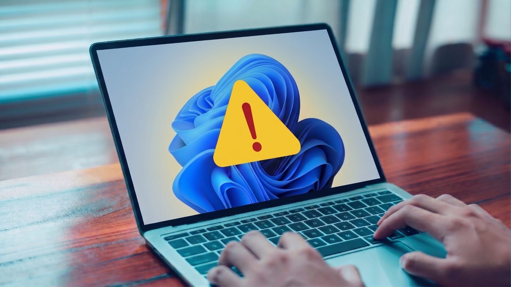 A Windows 11 laptop displaying a large warning sign
