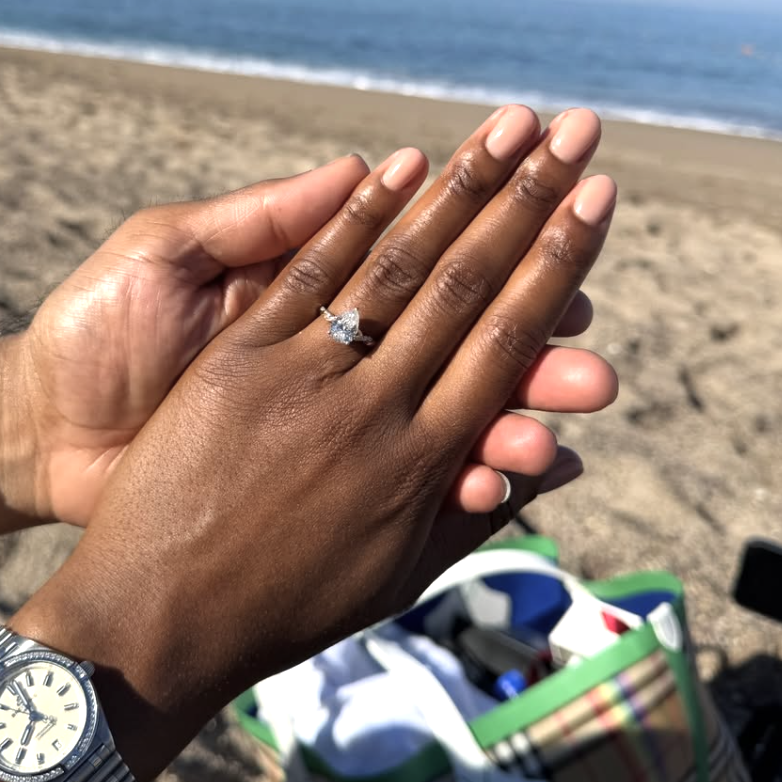 A woman wearing a soft nude manicure after getting engaged