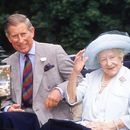 King Charles sitting in a carriage with the Queen Mother