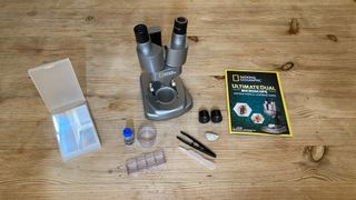 National Geographic Ultimate Dual Stereo Microscope and accessories on a table