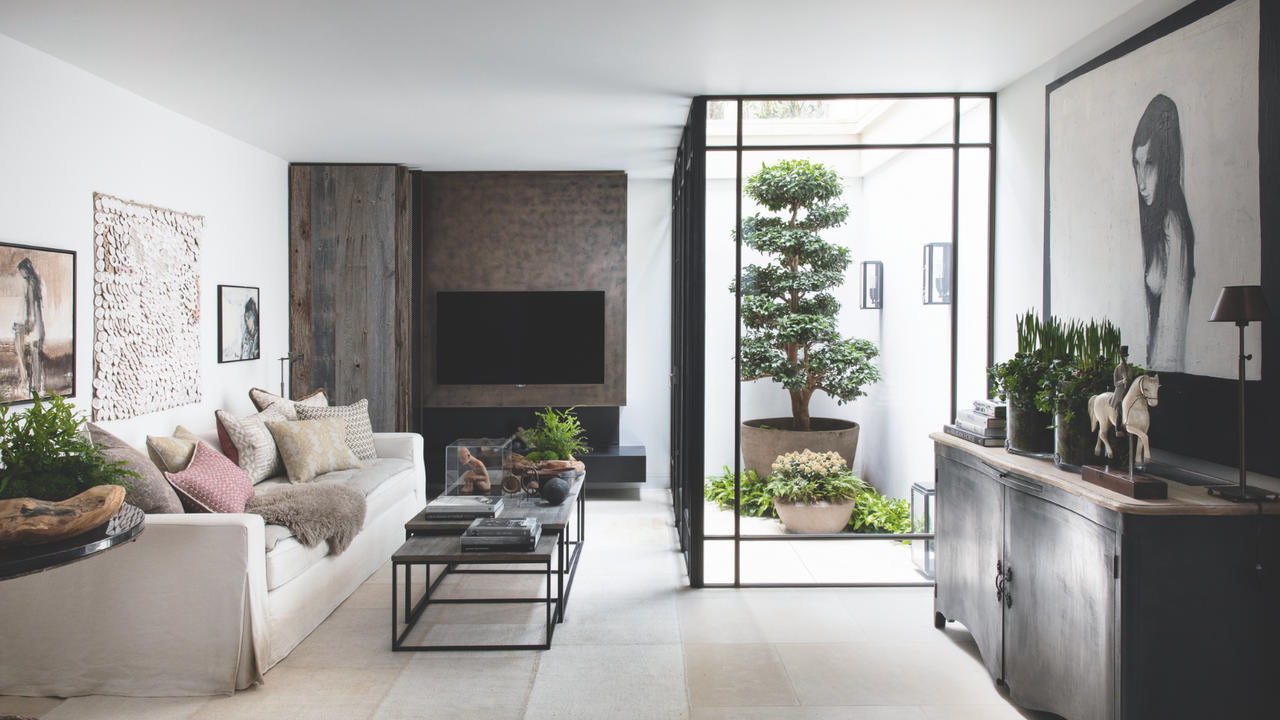 A converted basement with an internal courtyard and wall mounted TV