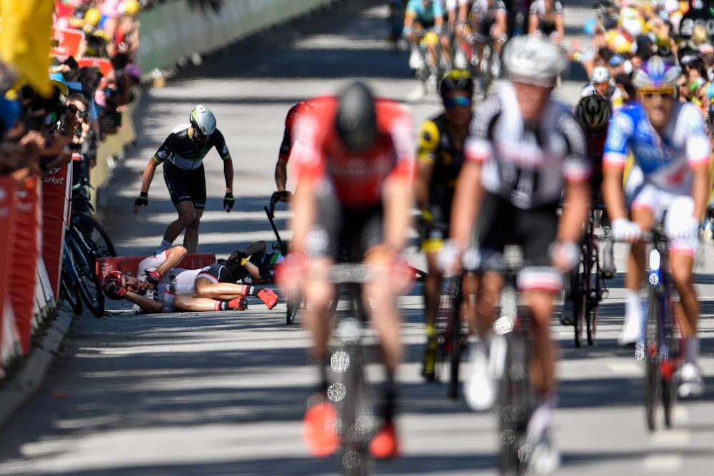 Riders lay on the ground after crashing in the finale of stage 4 at the Tour de France