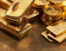 Gold ingots and coins close up