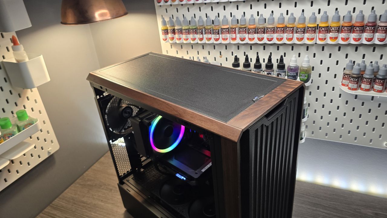 A Lian Li Lancool 217 on a desk with various components installed inside it.