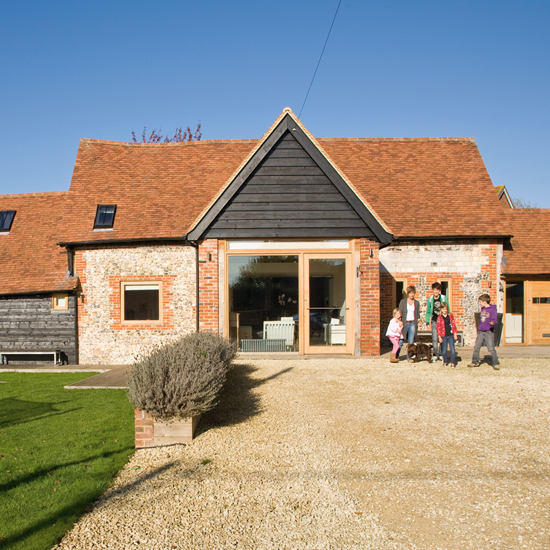 exterior with lawn area and shrubs