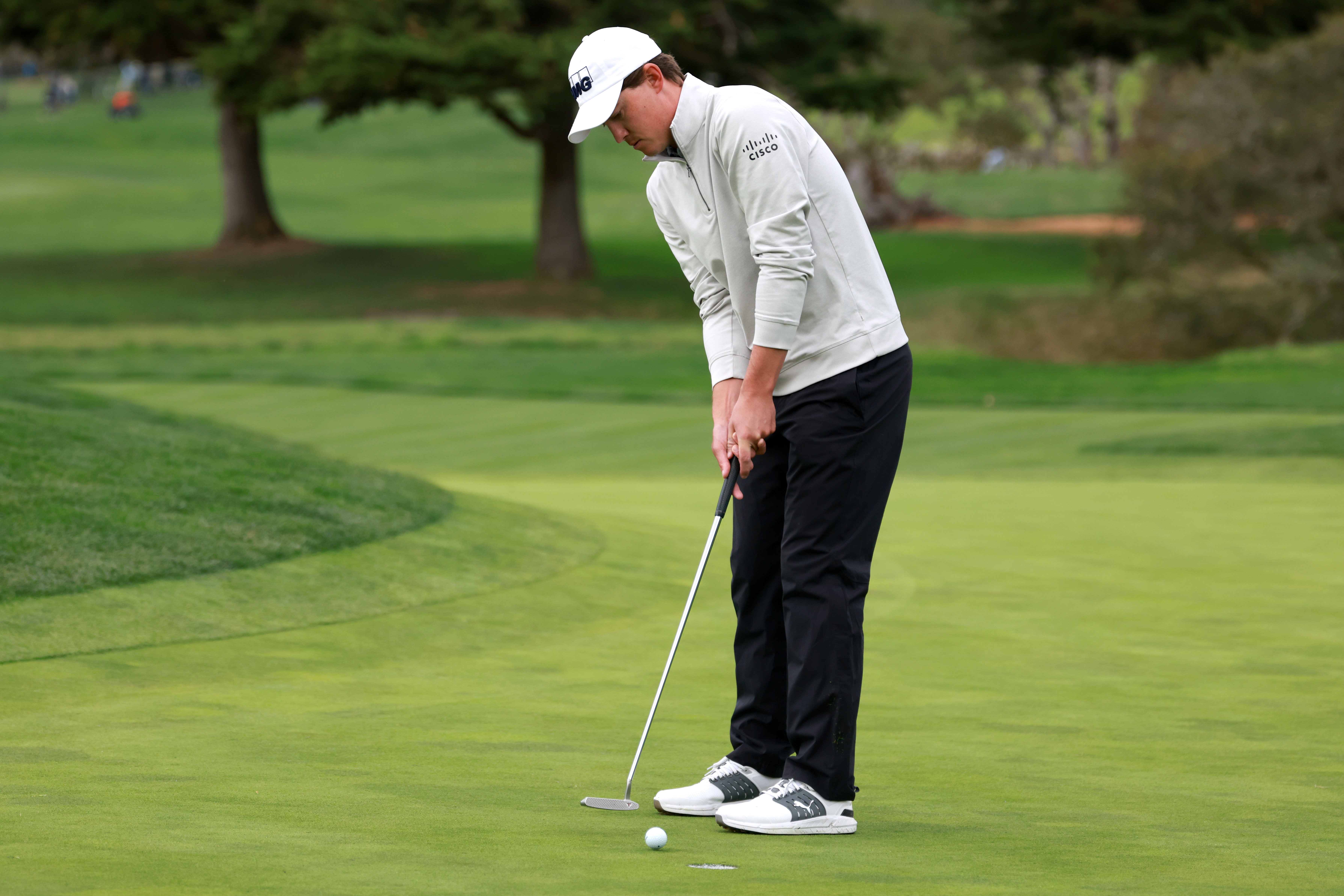Maverick McNealy strikes a putt