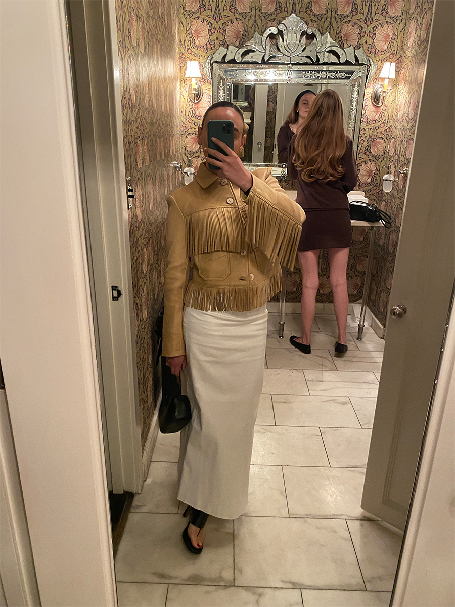@themillennialdecorator wearing a fringe jacket