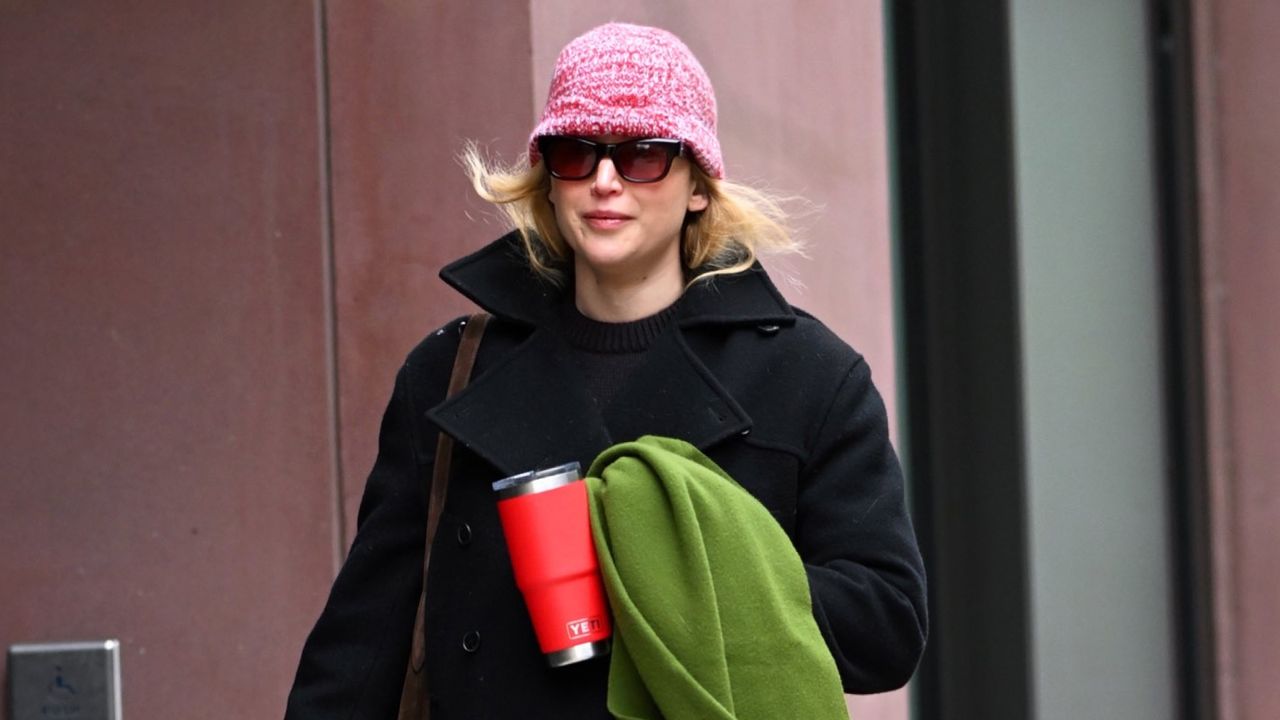 Jennifer Lawrence carries a Liffner bag with her Yeti mug and Dior coat in New York City