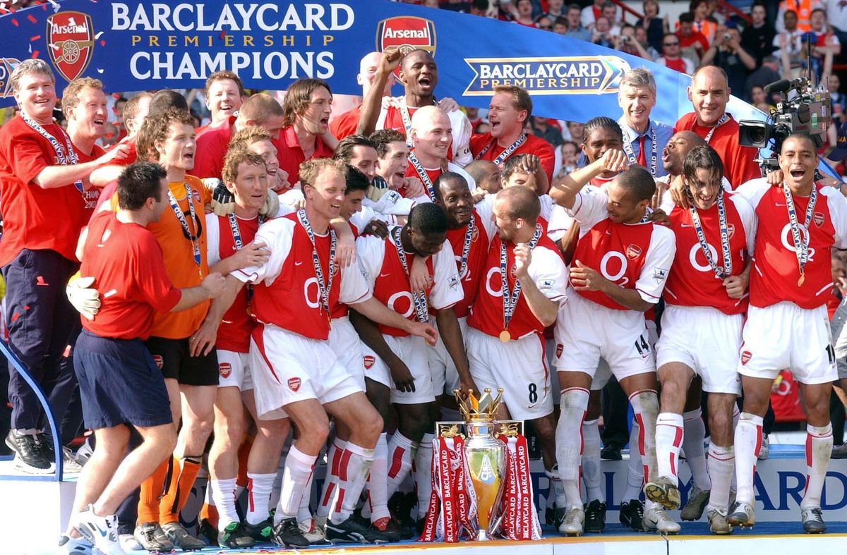 Arsenal celebrate with the trophy after winning the 2003/04 Premier League title