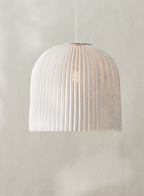 Curved pendant light made from a stainless steel mesh.
