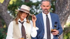 A man and a woman both wearing smart suits in cream and navy from House of Bruar.