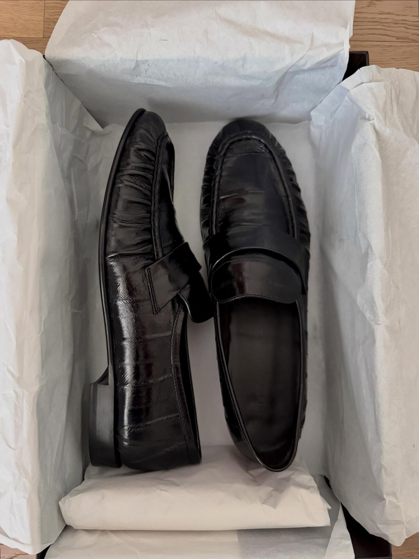 a pair of eel-skin The Row loafers