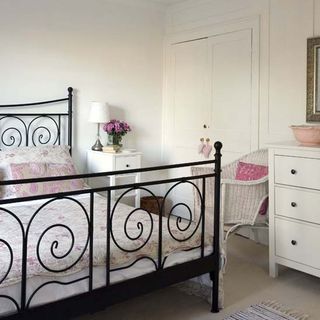 bedroom with white wall and pink floral bed linen
