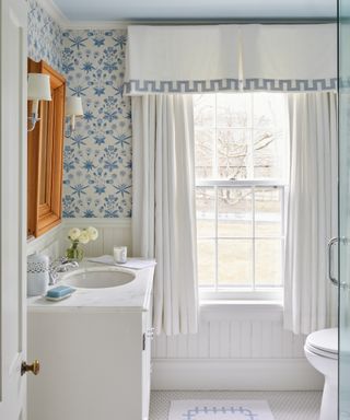 blue and white bathroom with patterned blue and white wallpaper