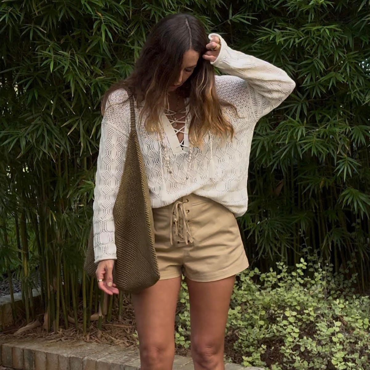 Angie wears a blouse and shorts from A.L.C 