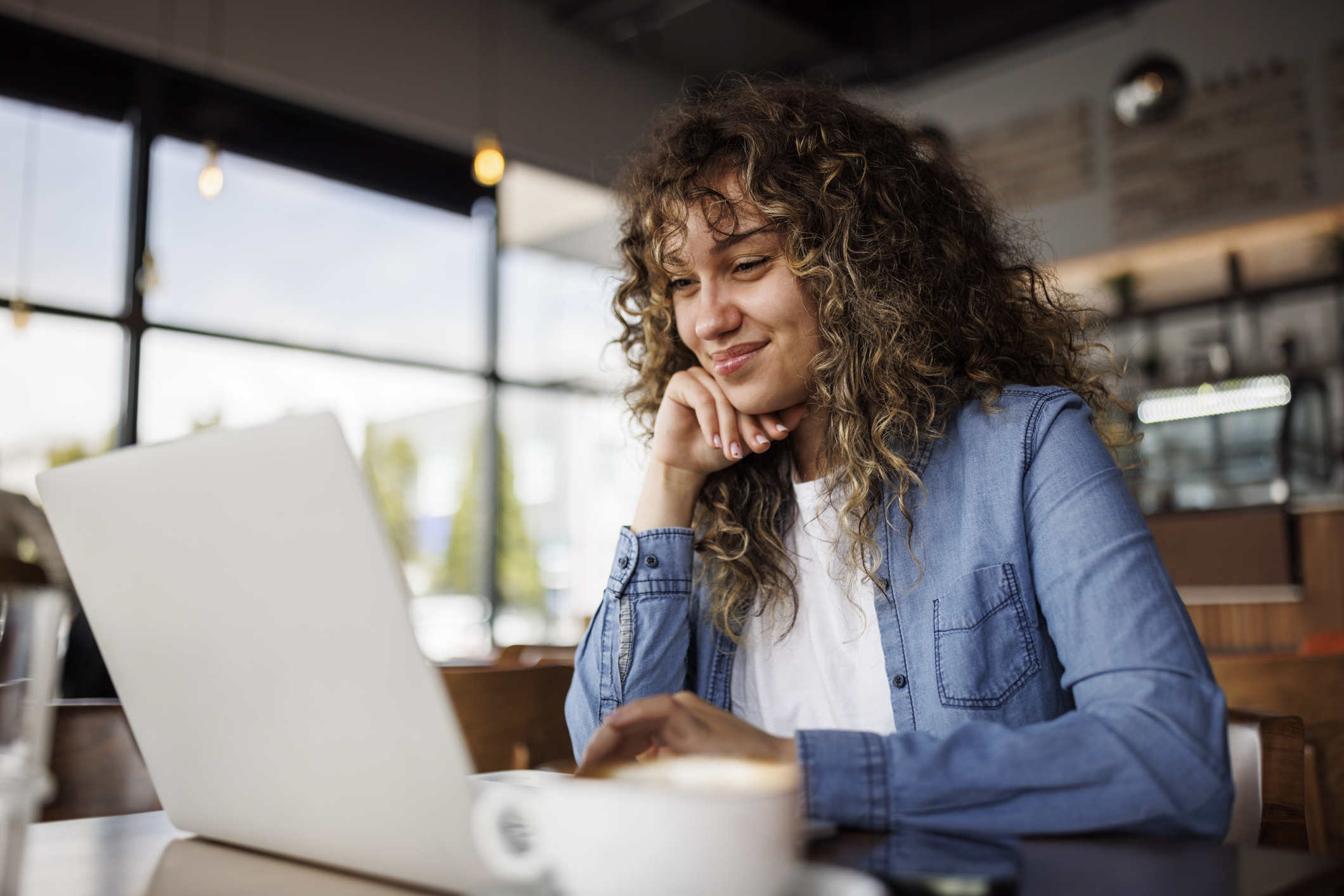 Woman looking at investments on laptop