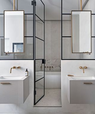 An example of modern bathroom ideas showing steel framed doors leading to a white bath