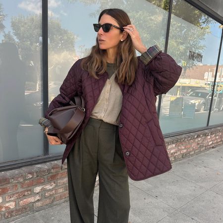 Fashion influencer Jen Azoulay wearing a chic fall outfit featuring a burgundy barn jacket and bag on the streets of New York City.