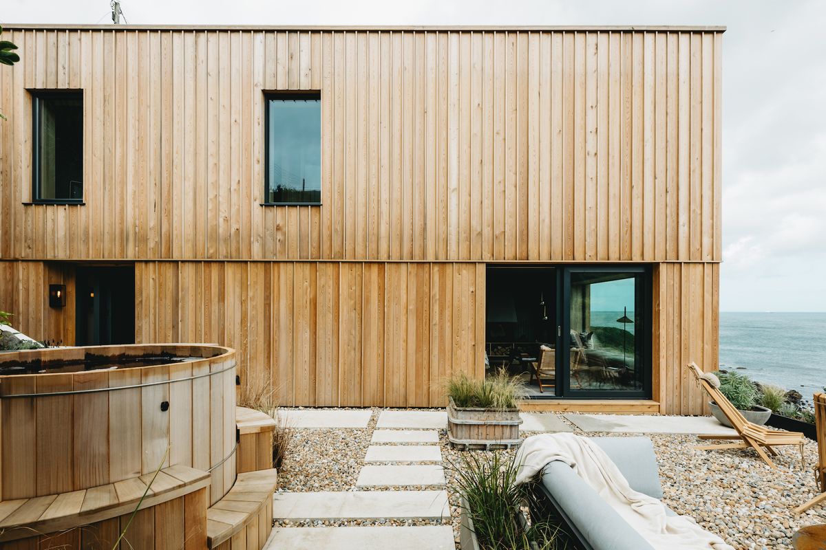 side view of timber clad exterior and hot tub