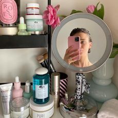 Woman taking a selfie in a vanity mirror