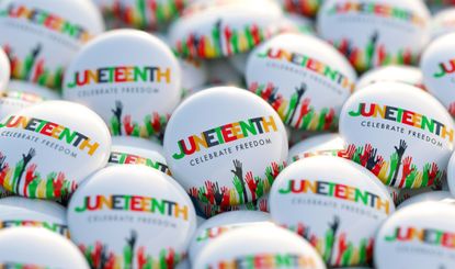 A pile of Juneteenth printed buttons that also say "celebrate freedom"