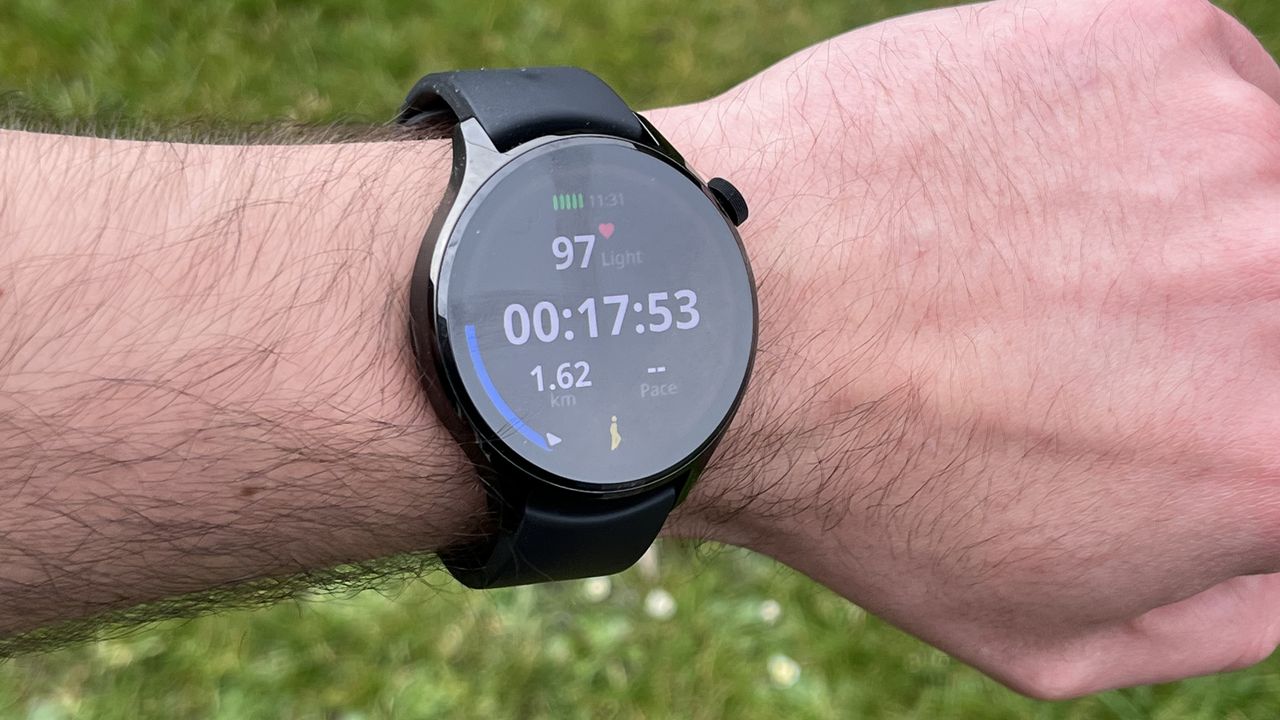 The Xiaomi Watch S1 Pro showing metrics from a workout, against a green background