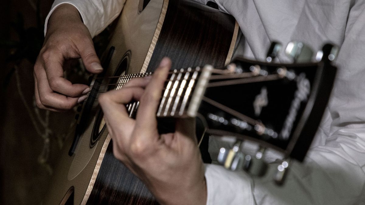 Close-up shot of guitarist playing Ibanez Fingerstyle Collection acoustic guitar