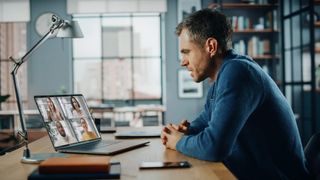 Remote worker attending virtual meeting on a laptop