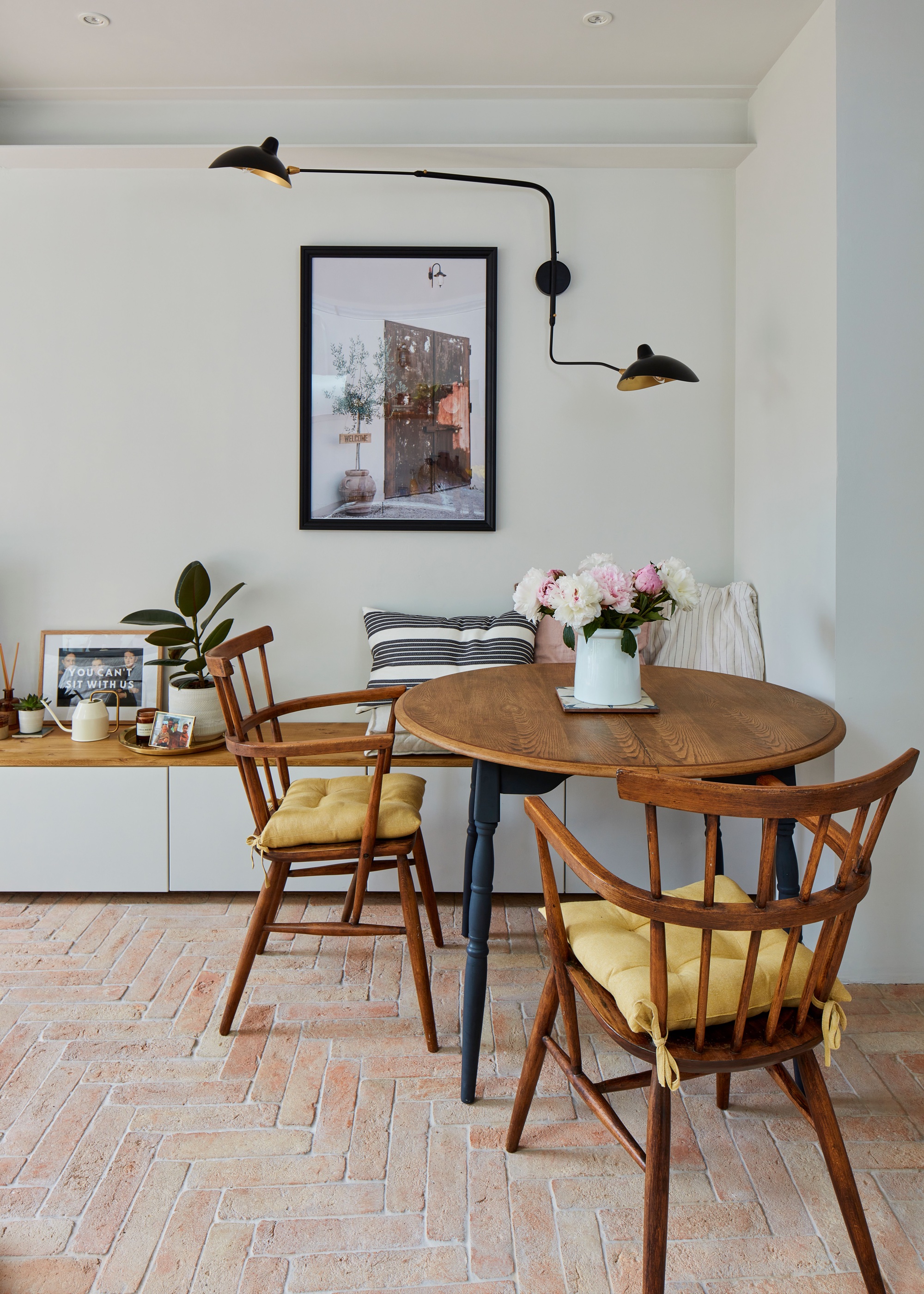 kitchen diner with repurposed table and chairs and parquet terracotta tile flooring