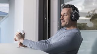 a man wearing the beyerdynamic amiron wireless over-ear headphones