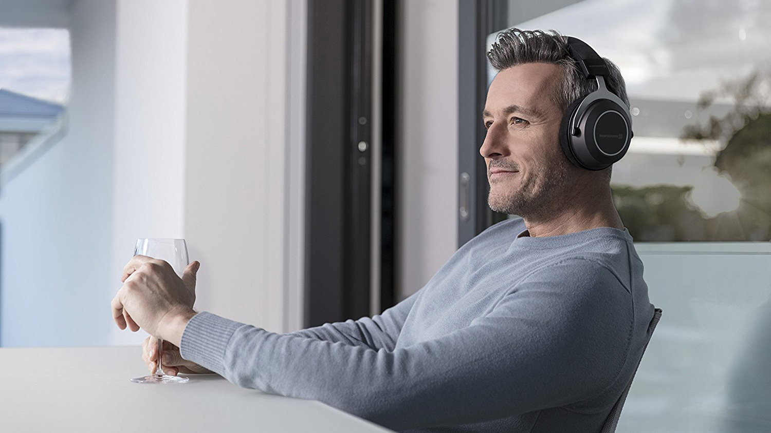 a man wearing the beyerdynamic amiron wireless over-ear headphones