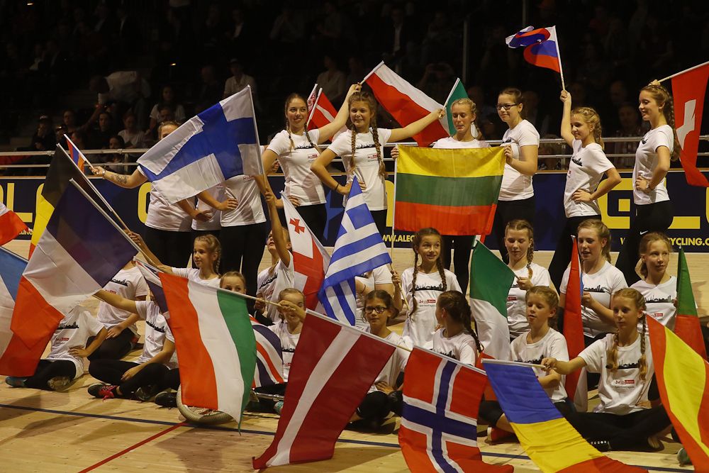 Children fly international flags at the European track championships
