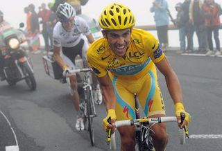 Alberto Contador attacks Andy Schleck near the fog-shrouded summit of the Tourmalet.